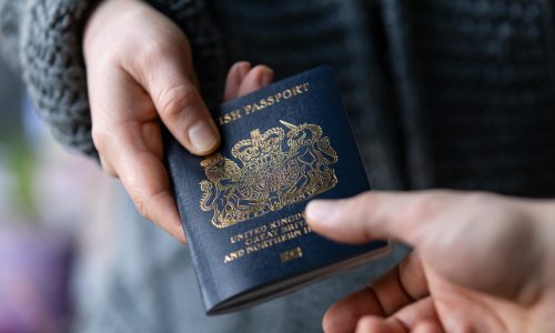 man handing new post Brexit blue British passport Devon, United Kingdom, January, 2021.